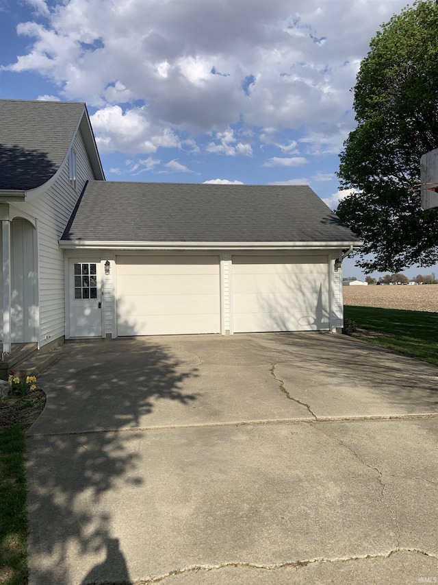 6921 Franke Rd, Fort Wayne, IN 46816 - view of side of property featuring driveway, an attached garage, and a shingled roof
