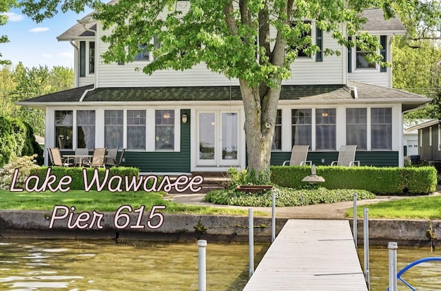 6592 E Waco Dr, Syracuse, IN 46567 - rear view of house featuring a sunroom, a shingled roof, a water view, and french doors
