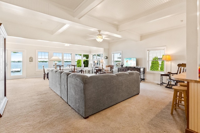 6592 E Waco Dr, Syracuse, IN 46567 - carpeted living area with beamed ceiling, a ceiling fan, healthy amount of natural light, and baseboards
