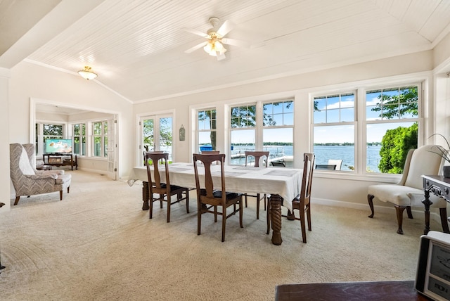 6592 E Waco Dr, Syracuse, IN 46567 - carpeted dining area with baseboards, a ceiling fan, a water view, vaulted ceiling, and crown molding