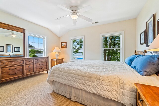 6592 E Waco Dr, Syracuse, IN 46567 - bedroom featuring light colored carpet, ceiling fan, and vaulted ceiling