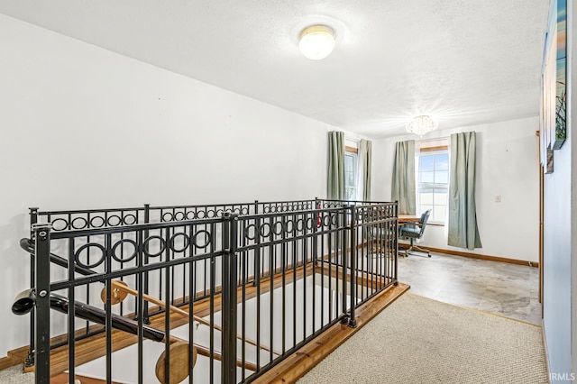 7205 N 1150 W, Shipshewana, IN 46565 - corridor with an upstairs landing, baseboards, and a textured ceiling
