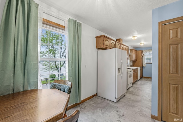 7205 N 1150 W, Shipshewana, IN 46565 - kitchen featuring white appliances, baseboards, and healthy amount of natural light