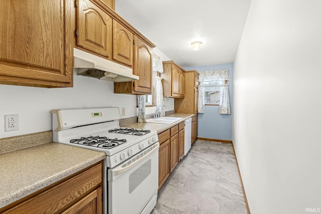 7205 N 1150 W, Shipshewana, IN 46565 - kitchen with white appliances, under cabinet range hood, a sink, light marble finish floors, and light countertops