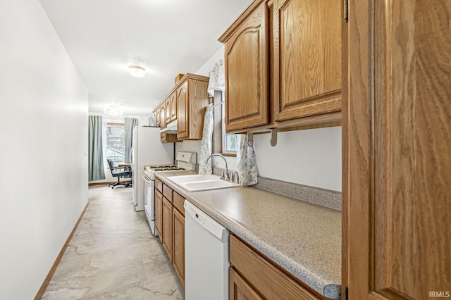 7205 N 1150 W, Shipshewana, IN 46565 - kitchen featuring white appliances, a sink, baseboards, light countertops, and brown cabinets