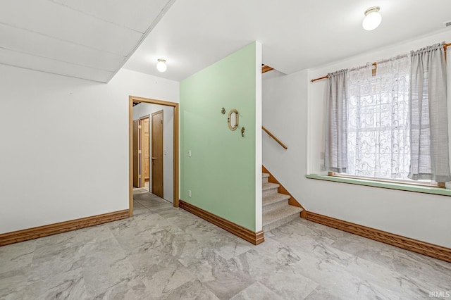 7205 N 1150 W, Shipshewana, IN 46565 - spare room featuring marble look tile flooring, stairway, and baseboards