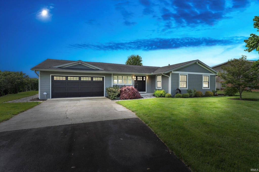 56449 Eastvue Dr, Osceola, IN 46561 - ranch-style house featuring an attached garage, a front yard, and concrete driveway