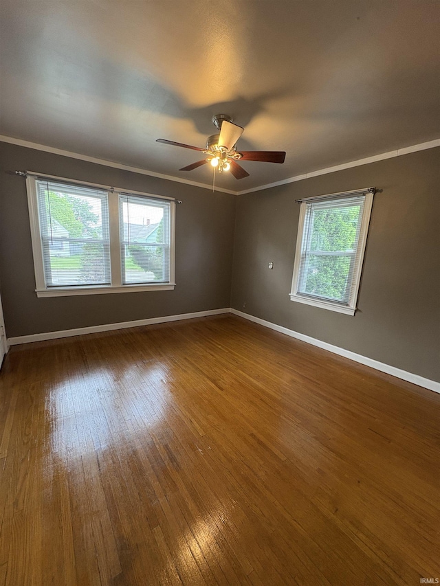 1713 E Illinois St, Evansville, IN 47711 - unfurnished room with baseboards, hardwood / wood-style flooring, crown molding, and a ceiling fan