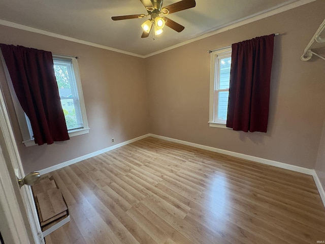 1713 E Illinois St, Evansville, IN 47711 - spare room with ornamental molding, baseboards, light wood-style floors, and a ceiling fan