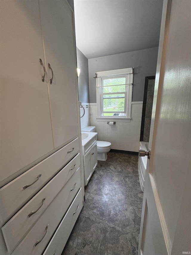 1713 E Illinois St, Evansville, IN 47711 - full bath with toilet, vanity, wainscoting, tile walls, and a bath