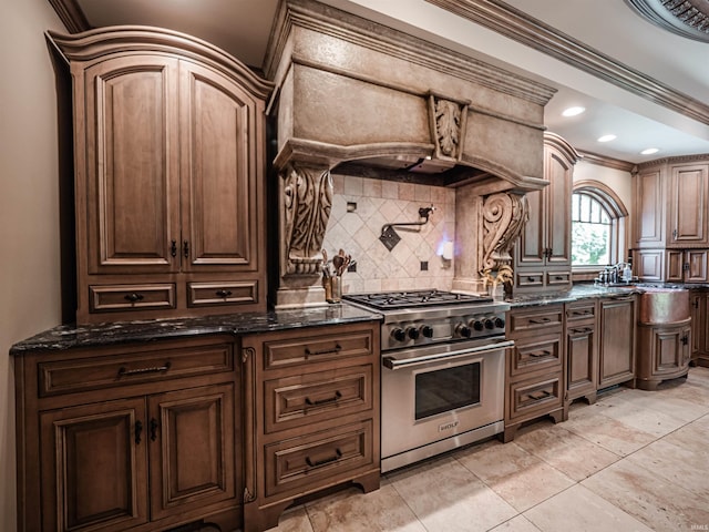 703 Pfeiffer Rd, Evansville, IN 47711 - kitchen featuring high end stainless steel range, backsplash, dark stone countertops, and crown molding