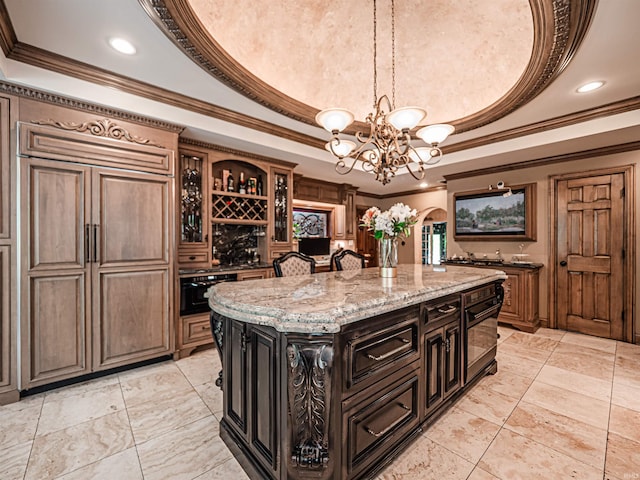 703 Pfeiffer Rd, Evansville, IN 47711 - kitchen with a tray ceiling, crown molding, a chandelier, a center island, and light stone countertops