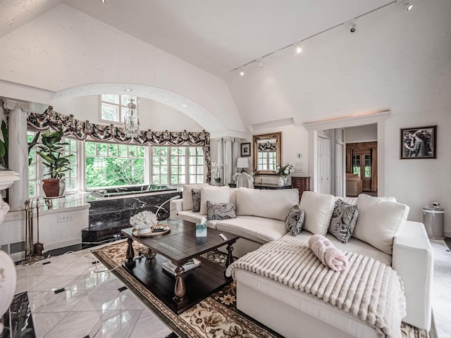 703 Pfeiffer Rd, Evansville, IN 47711 - living area featuring rail lighting, light marble finish flooring, and high vaulted ceiling
