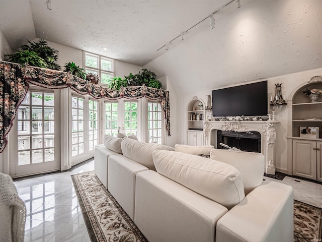 703 Pfeiffer Rd, Evansville, IN 47711 - living room with track lighting, a fireplace, built in features, lofted ceiling, and a textured ceiling