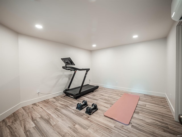 703 Pfeiffer Rd, Evansville, IN 47711 - exercise area with recessed lighting, wood finished floors, baseboards, and a wall unit AC