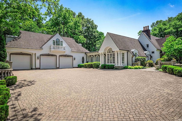703 Pfeiffer Rd, Evansville, IN 47711 - view of front facade featuring a garage, decorative driveway, and roof with shingles