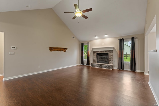 32840 Morning Dove Ct, New Carlisle, IN 46552 - unfurnished living room with high vaulted ceiling, a ceiling fan, dark wood-type flooring, a fireplace, and baseboards