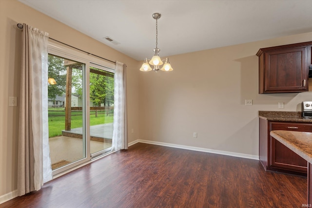 32840 Morning Dove Ct, New Carlisle, IN 46552 - unfurnished dining area featuring a chandelier, dark wood-style flooring, and baseboards