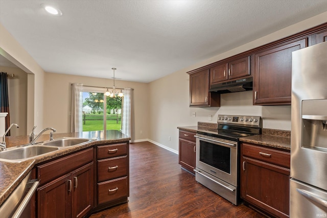 32840 Morning Dove Ct, New Carlisle, IN 46552 - kitchen featuring appliances with stainless steel finishes, under cabinet range hood, a sink, dark countertops, and dark wood-style flooring