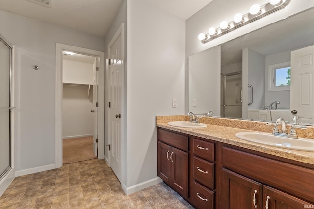 32840 Morning Dove Ct, New Carlisle, IN 46552 - bathroom featuring a shower stall, double vanity, baseboards, a tub, and a walk in closet