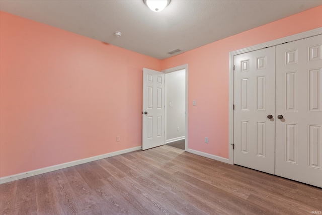 32840 Morning Dove Ct, New Carlisle, IN 46552 - unfurnished bedroom with wood finished floors, baseboards, and a closet