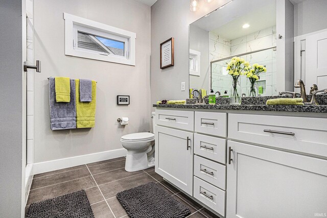 53760 Terre Verde Hills Ct, South Bend, IN 46628 - bathroom with vanity, a shower stall, toilet, tile patterned flooring, and baseboards