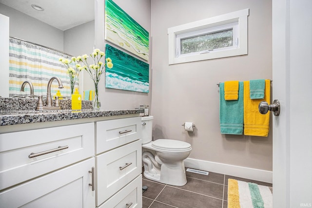 53760 Terre Verde Hills Ct, South Bend, IN 46628 - full bath with toilet, baseboards, vanity, and tile patterned floors