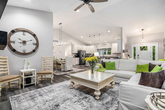 53760 Terre Verde Hills Ct, South Bend, IN 46628 - living area featuring dark wood-type flooring, a ceiling fan, high vaulted ceiling, baseboards, and a chandelier