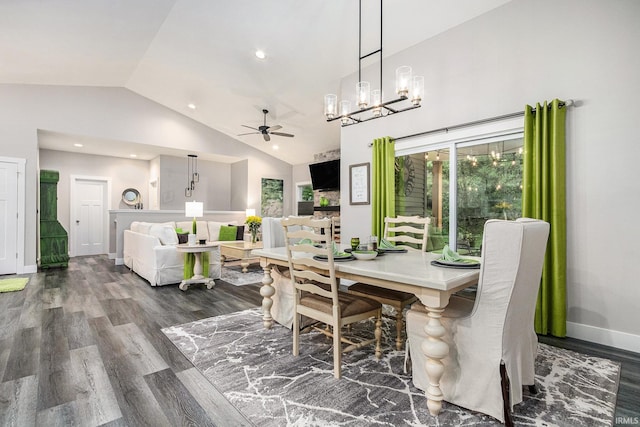 53760 Terre Verde Hills Ct, South Bend, IN 46628 - dining area featuring a ceiling fan, wood finished floors, a chandelier, baseboards, and high vaulted ceiling
