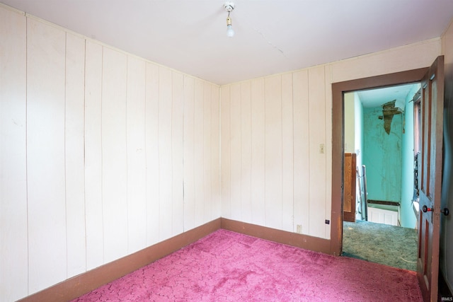 104 S Cowen St, Garrett, IN 46738 - empty room featuring carpet flooring, baseboards, and wood walls