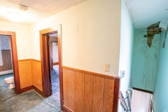 104 S Cowen St, Garrett, IN 46738 - hallway featuring carpet, a wainscoted wall, and wood walls