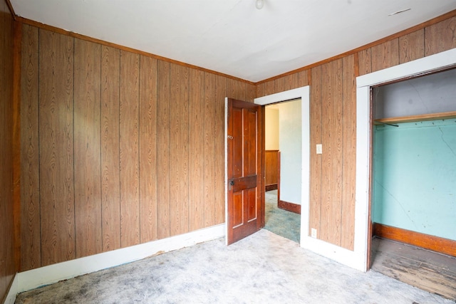 104 S Cowen St, Garrett, IN 46738 - unfurnished bedroom featuring carpet, a closet, wood walls, and baseboards