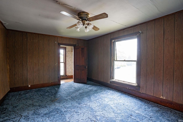 104 S Cowen St, Garrett, IN 46738 - unfurnished room featuring carpet, a ceiling fan, wood walls, and baseboards