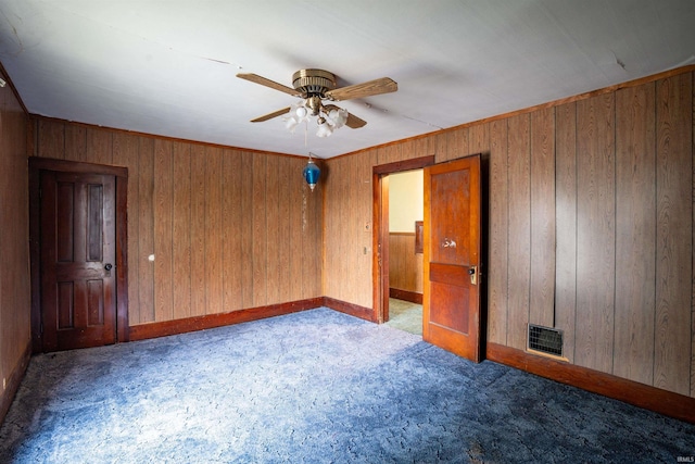 104 S Cowen St, Garrett, IN 46738 - unfurnished room featuring carpet, ceiling fan, wood walls, and baseboards