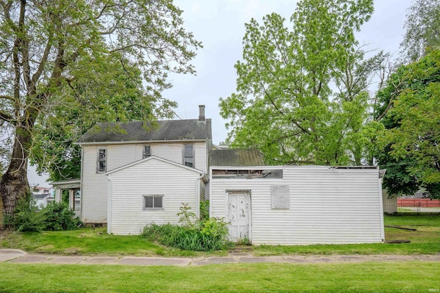 104 S Cowen St, Garrett, IN 46738 - back of house with a lawn, a chimney, and a shingled roof