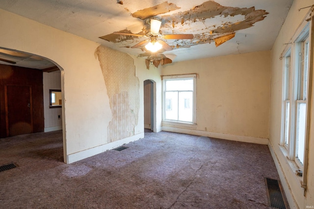 104 S Cowen St, Garrett, IN 46738 - carpeted empty room featuring arched walkways, ceiling fan, and baseboards