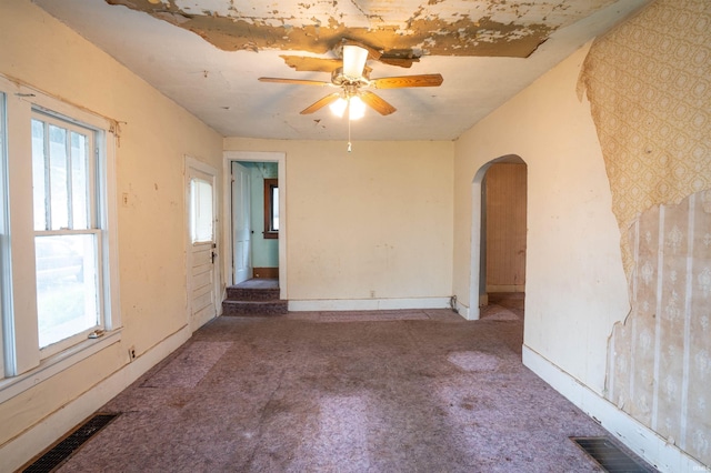 104 S Cowen St, Garrett, IN 46738 - spare room with arched walkways, carpet, and a ceiling fan