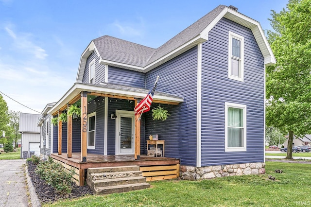1258 N Main St, Nappanee, IN 46550 - view of front of home featuring covered porch, a front yard, and a shingled roof