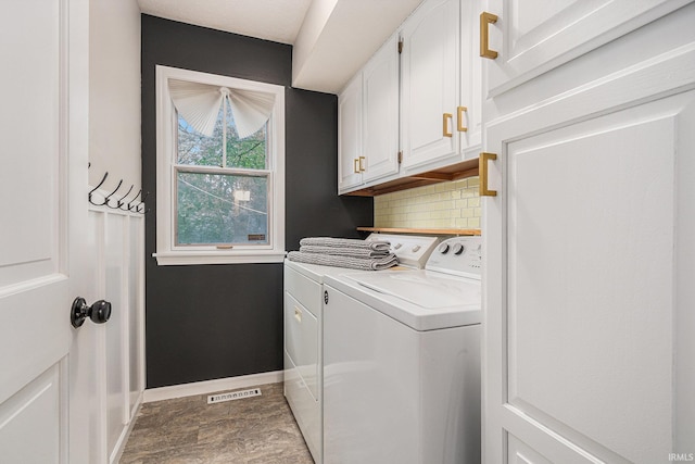 51695 Fox Pointe Ln, Granger, IN 46530 - laundry room with washer and clothes dryer, cabinet space, and baseboards
