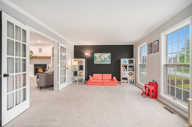 51695 Fox Pointe Ln, Granger, IN 46530 - living area with french doors, carpet floors, ornamental molding, and a brick fireplace