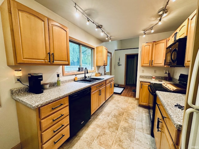 50959 Michigan Rd, South Bend, IN 46637 - kitchen featuring a sink, black appliances, rail lighting, and light stone countertops