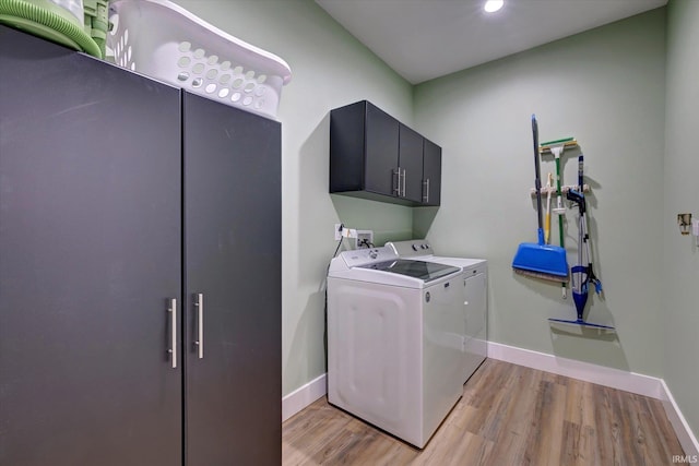 4022 Eagle Dr, Gosport, IN 47433 - laundry room with washing machine and dryer, light wood finished floors, baseboards, recessed lighting, and cabinet space