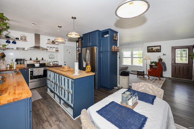 110 Alan Dr, Fremont, IN 46737 - kitchen with butcher block countertops, open shelves, wall chimney range hood, blue cabinetry, and stainless steel appliances