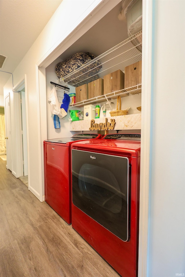 110 Alan Dr, Fremont, IN 46737 - laundry room with washer and dryer and wood finished floors