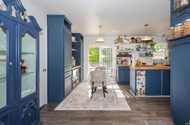 110 Alan Dr, Fremont, IN 46737 - kitchen featuring open shelves, wood counters, blue cabinets, decorative backsplash, and dark wood-type flooring