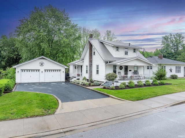 1471 Vernon St, Wabash, IN 46992 - traditional-style home featuring covered porch, an outdoor structure, a detached garage, metal roof, and a chimney