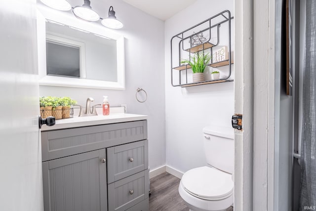 1471 Vernon St, Wabash, IN 46992 - half bathroom with vanity, toilet, wood finished floors, and baseboards
