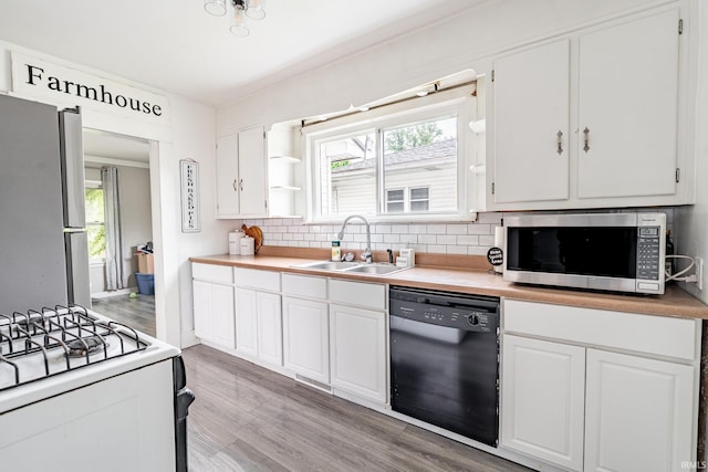 1471 Vernon St, Wabash, IN 46992 - kitchen featuring stainless steel appliances, a sink, light wood-style flooring, and white cabinetry