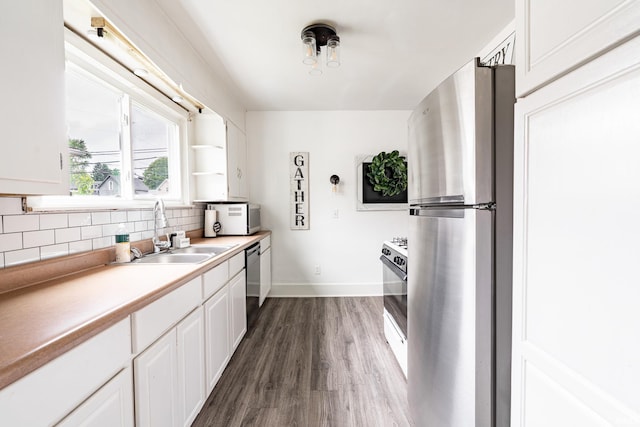 1471 Vernon St, Wabash, IN 46992 - kitchen featuring freestanding refrigerator, a sink, backsplash, dark wood finished floors, and baseboards