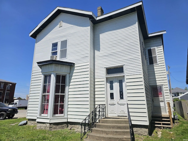 58 E 5th St, Peru, IN 46970 - rear view of house featuring entry steps and a chimney